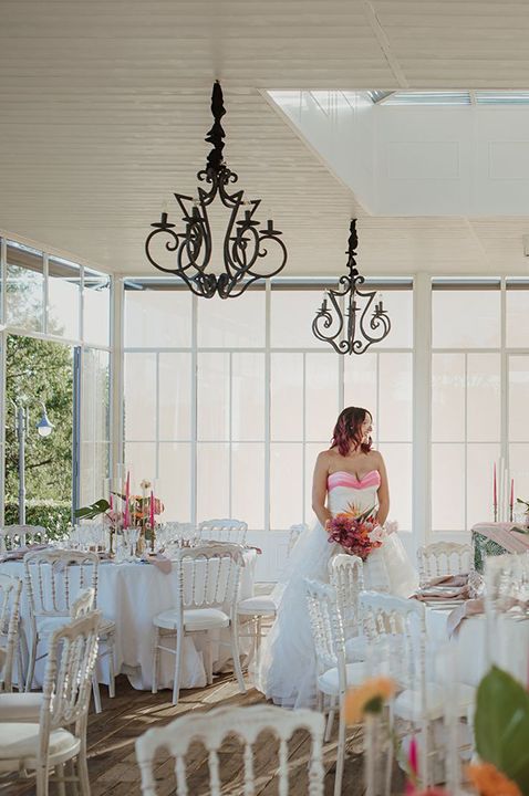  Le Due Torrette wedding venue in Italy - Bride and groom in empty indoor reception with tables and chairs 