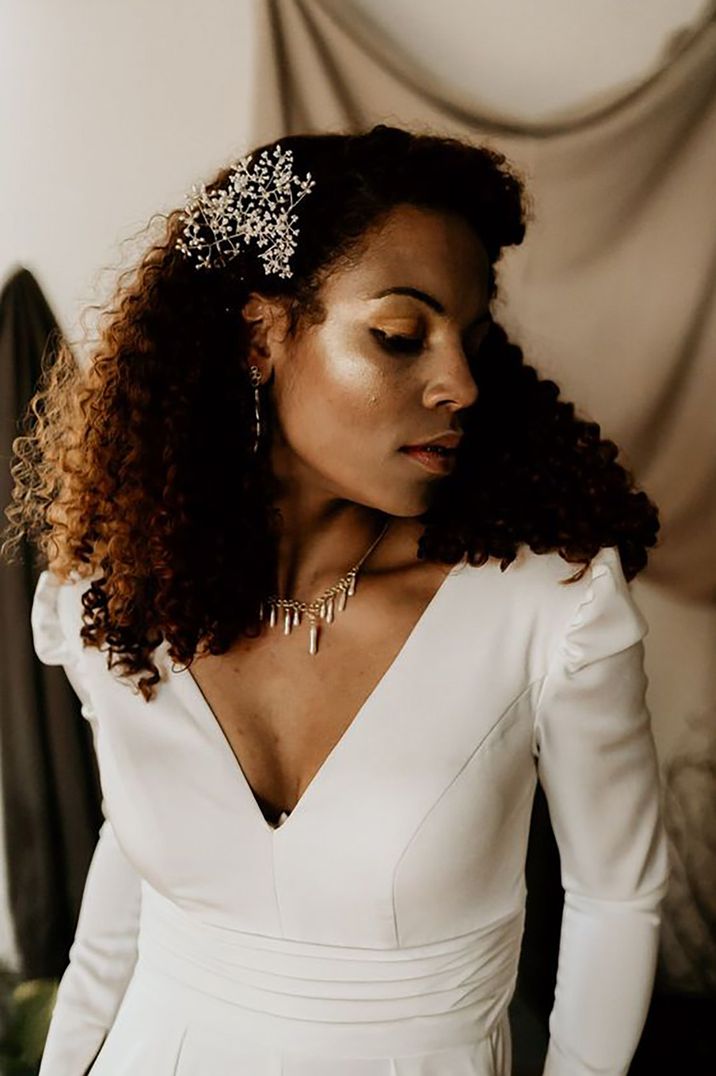 bride with afro curly hair and flower wedding hair accessory