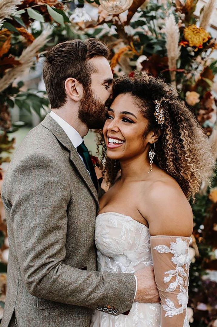 bride with afro curly hair and gold wedding hair accessory