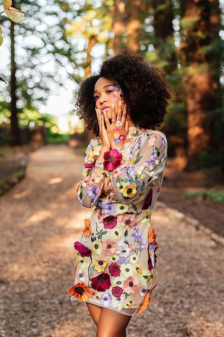 bride with colourful floral wedding dress and afro curly hair