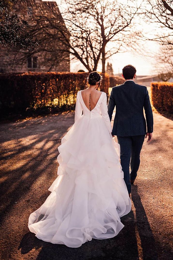 Bride in low back dress with full princess ruffle skirt