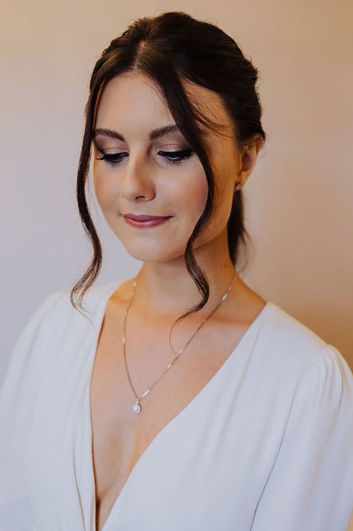 bride wearing a simple silver pendant wedding necklace