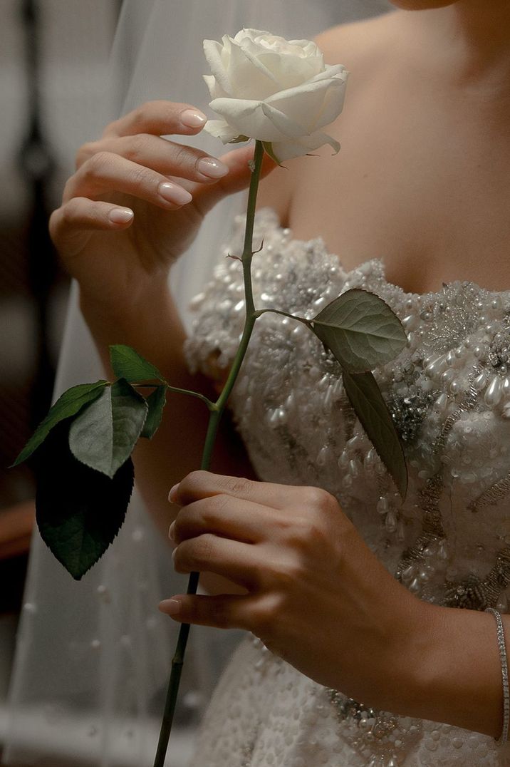 bride-with-neutral-wedding-nails-with-white-rose