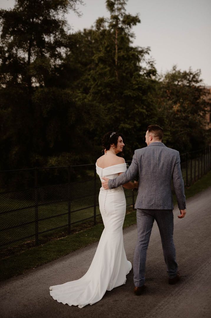 bride-and-groom-walking-together-at-tithe-barn