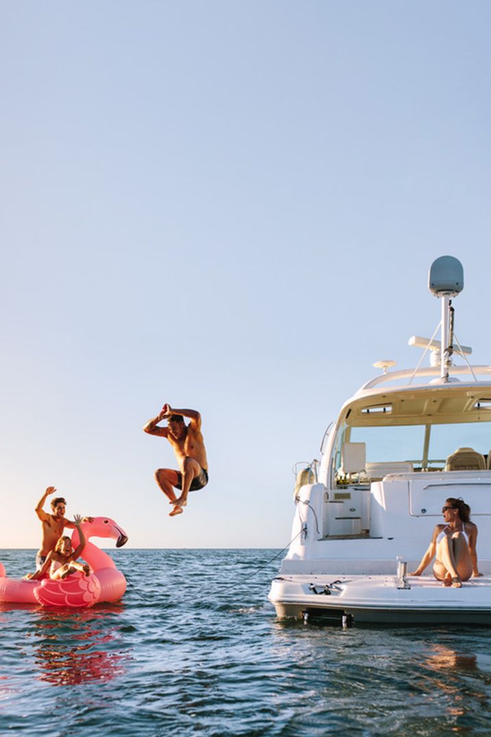 group-of-friends-diving-swimming-and-partying-on-boat-for-party