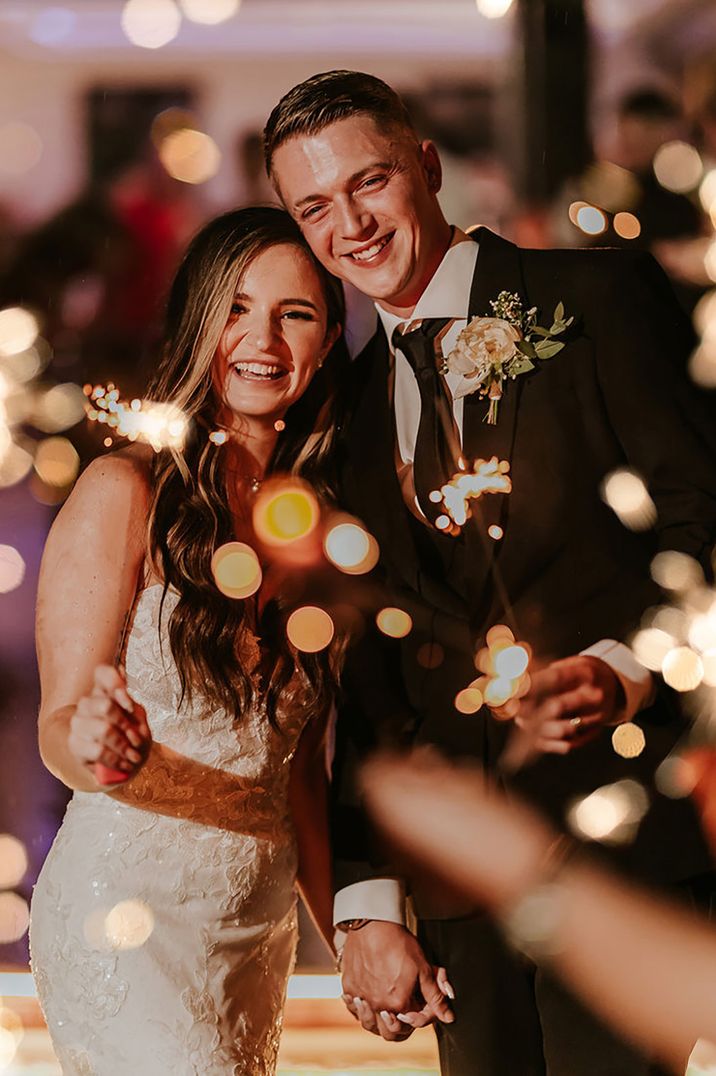 bride-and-groom-smiling-during-sparkler-send-off