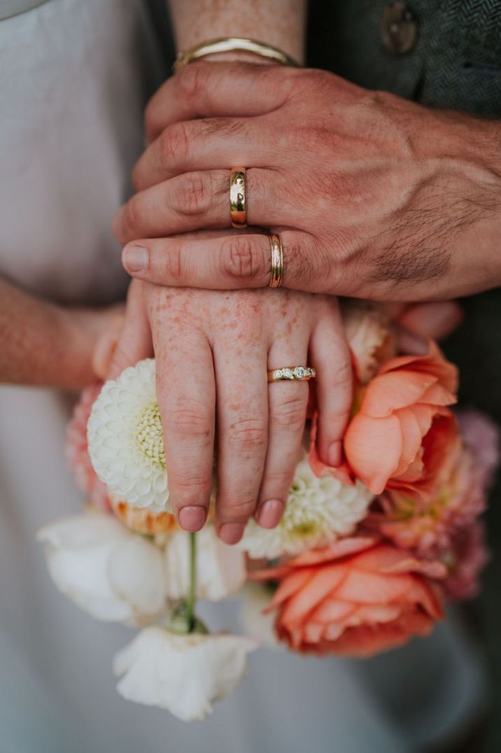 Bride & Groom Wearing Gold Wedding Bands