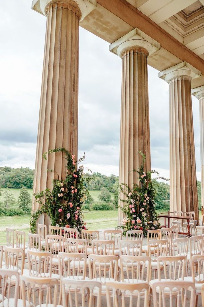 pink-flower-column-decorations-at-outdoor-wedding-ceremony