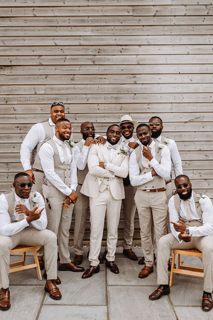 groomsmen-in-beige-waistcoats-and-white-shirts-at-boho-glam-wedding