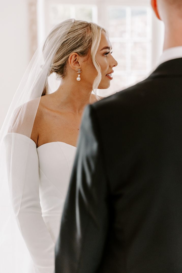 bride-wearing-pearl-drop-wedding-earrings