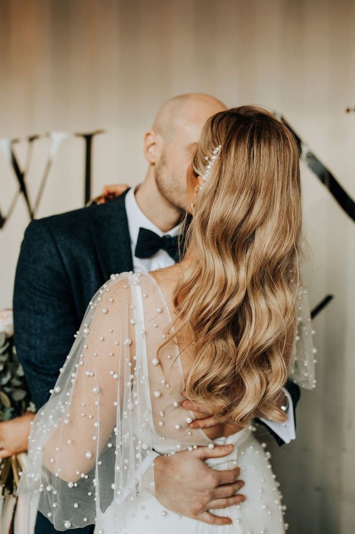 bride-in-a-pearl-wedding-dress-with-long-curled-blonde-hair