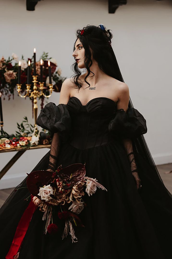 Bride wearing off the shoulder sweetheart black wedding dress