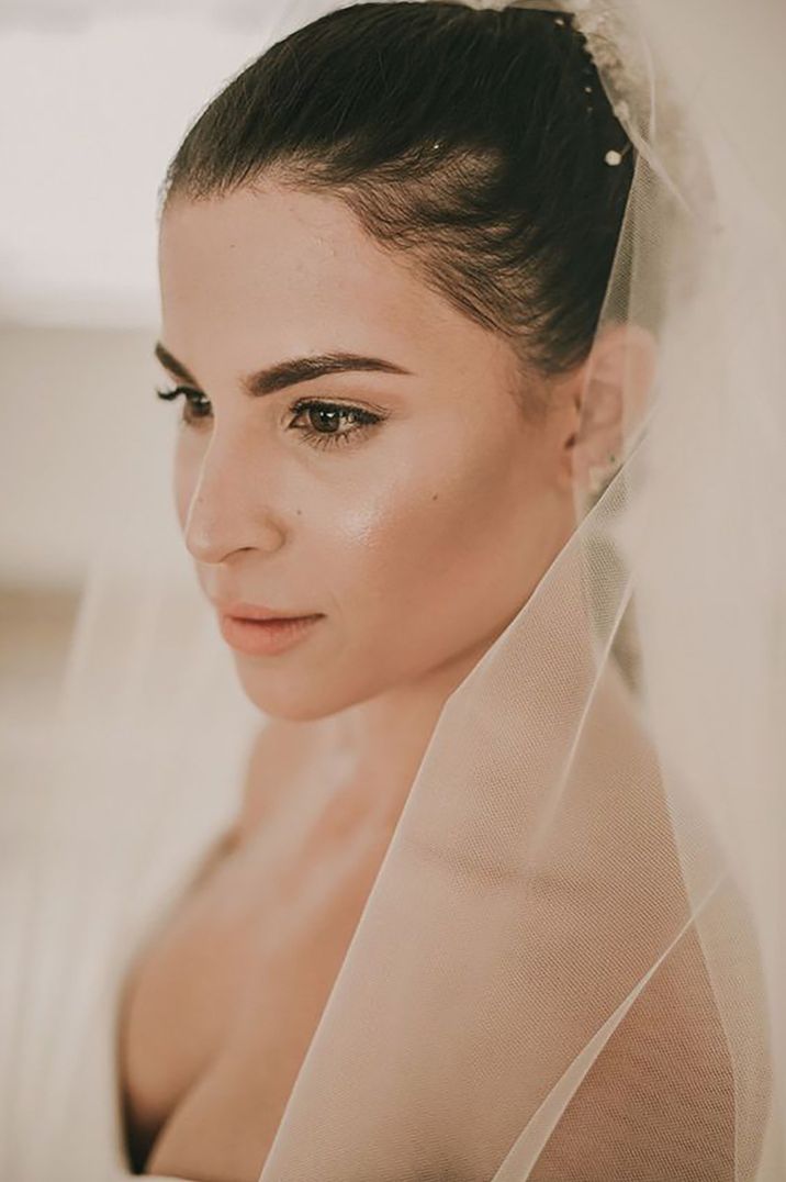 bride with natural makeup look for wedding day and dewy, glowy skin