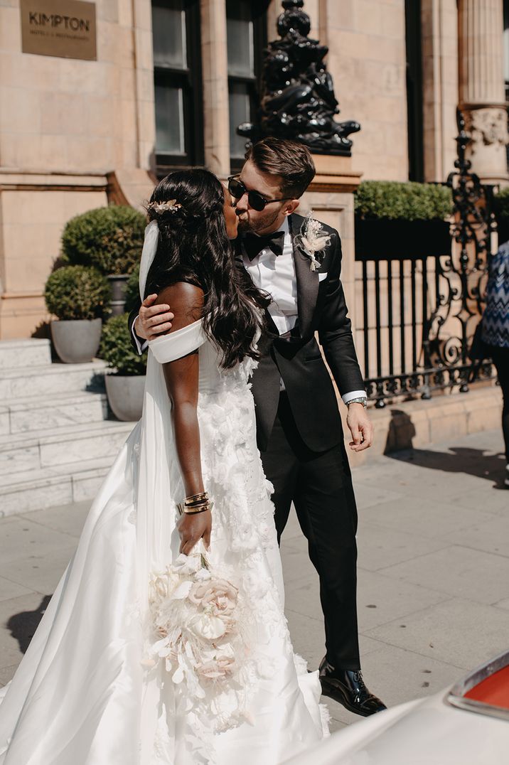 bride-in-off-the-shoulder-wedding-dress-kissing-groom