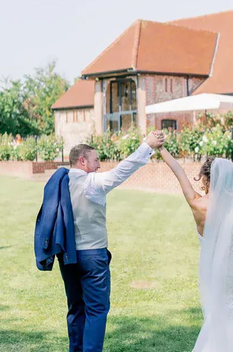 tuffon hall vineyard wedding venue, couple on main lawn on their wedding day