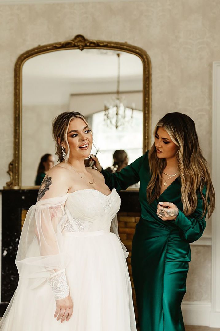 wedding guest/ bridesmaids wearing emerald green satin long sleeve wedding guest dress