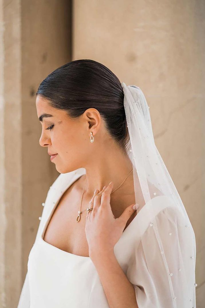 bride wearing silver pearl delicate wedding jewellery