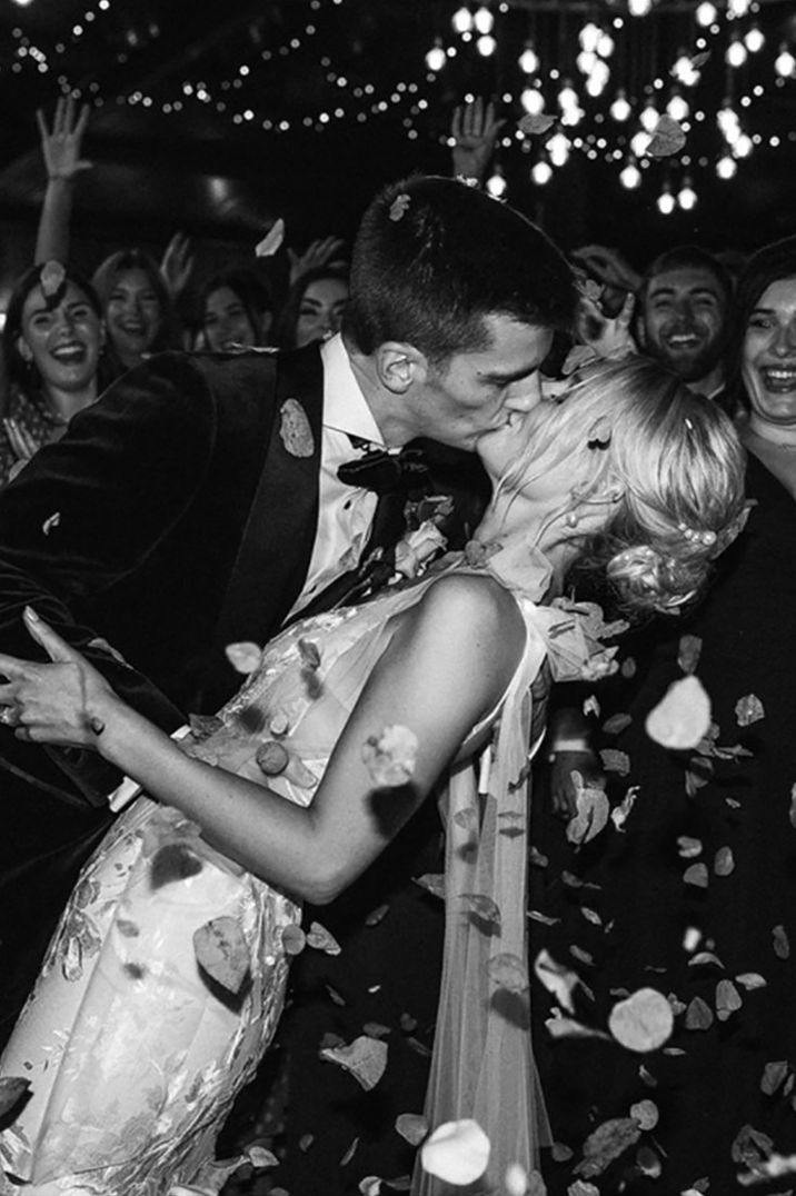 confetti-moment-for-bride-and-groom-as-they-kiss