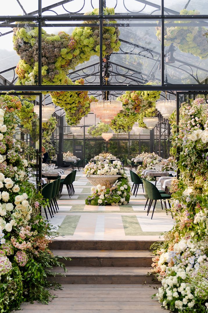 luxe-glass-marquee-decorated-with-white-flowers-and-flower-columns