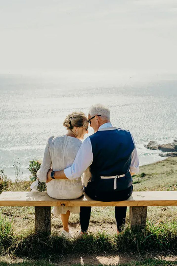 couple-sitting-looking-at-coast