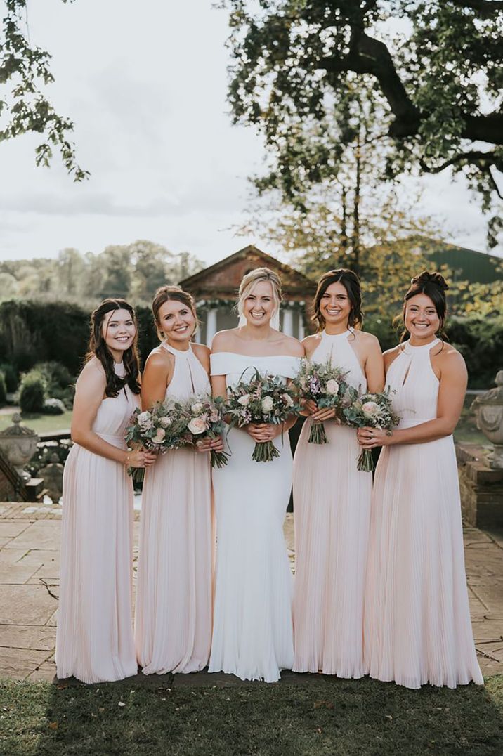 bride with bridesmaids wearing blush pink bridesmaid dresses