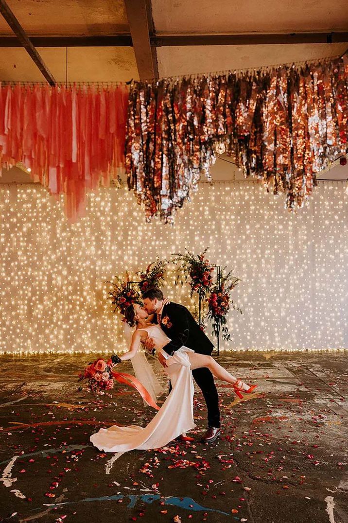 bride and groom with disco themed metallic wedding and streamers