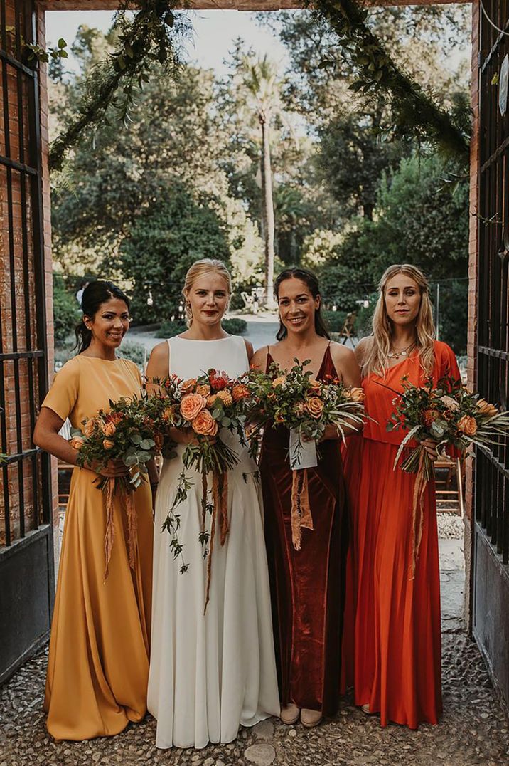 mismatched orange toned bridesmaid dresses