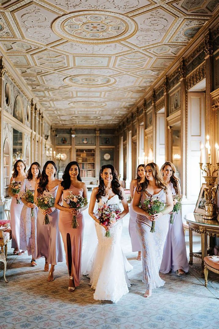 bride with her bridesmaids wearing lavender bridesmaid dresses