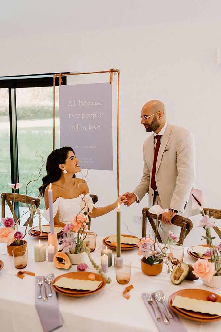 bride and groom at head table with lavender wedding theme and table decor