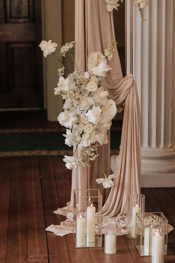 neutral wedding decor, including flowers and candles