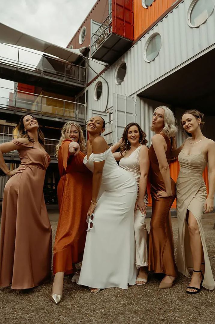 mismatched orange and neutral toned bridesmaid dresses