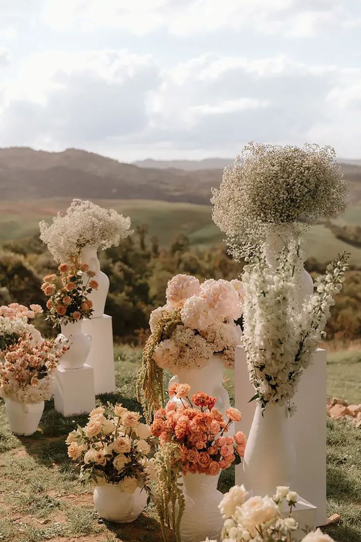 neutral wedding flowers in sculpted statement pots