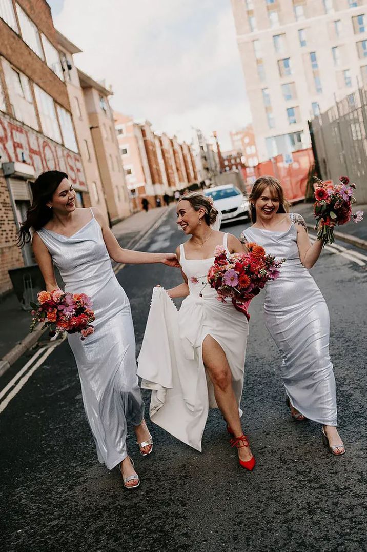 bride with bridesmaids wearing silver metallic dresses