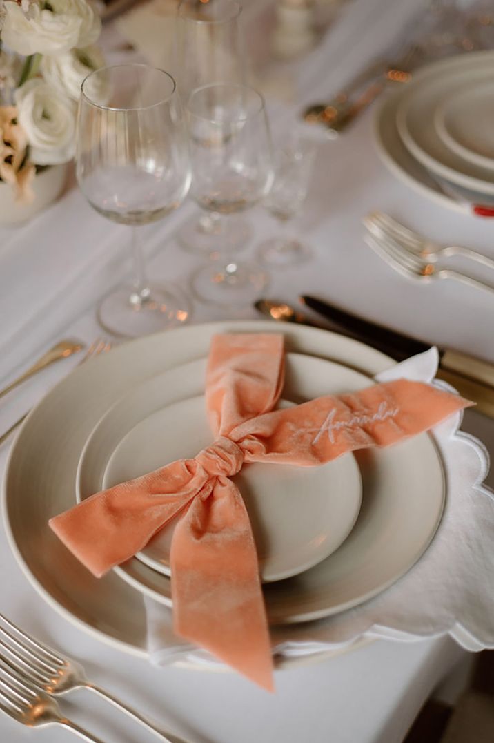 peach table decor for wedding, including velvet peach bow