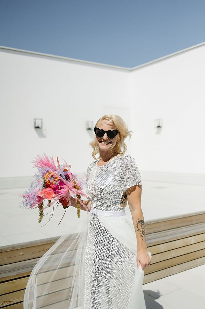 older bride wearing sequin silver coloured wedding dress 