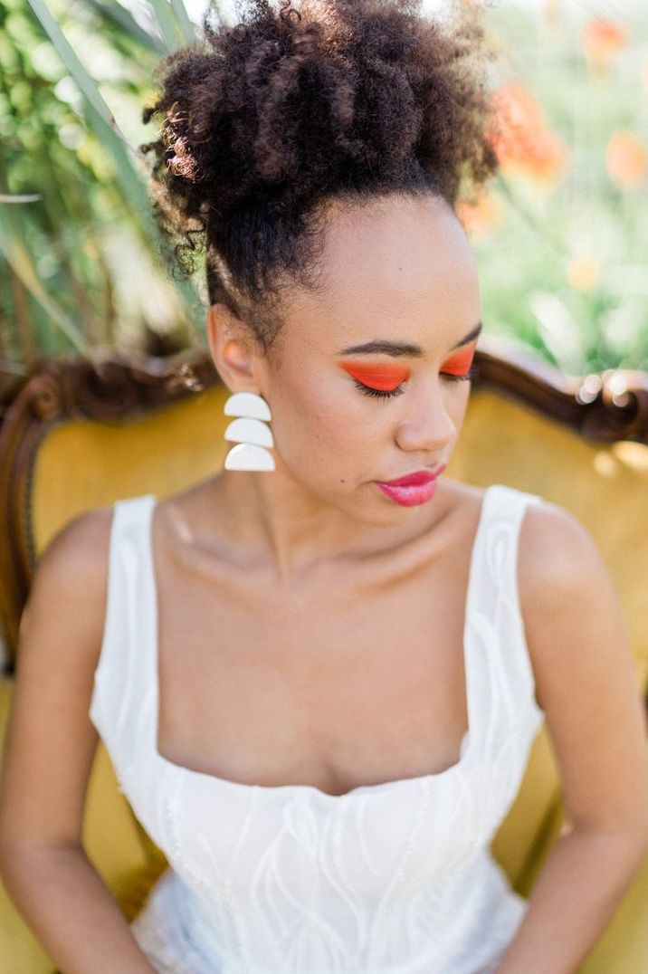 bride-wearing-bright-orange-wedding-makeup-with-pink-lipstick