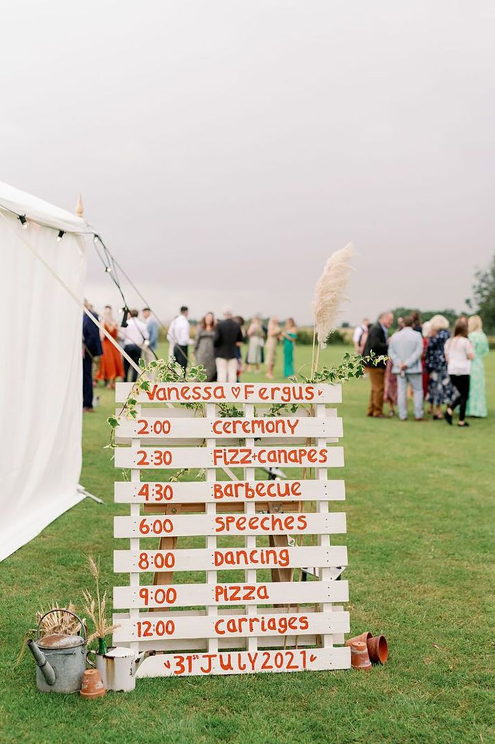 wooden pallet wedding order of the day sign