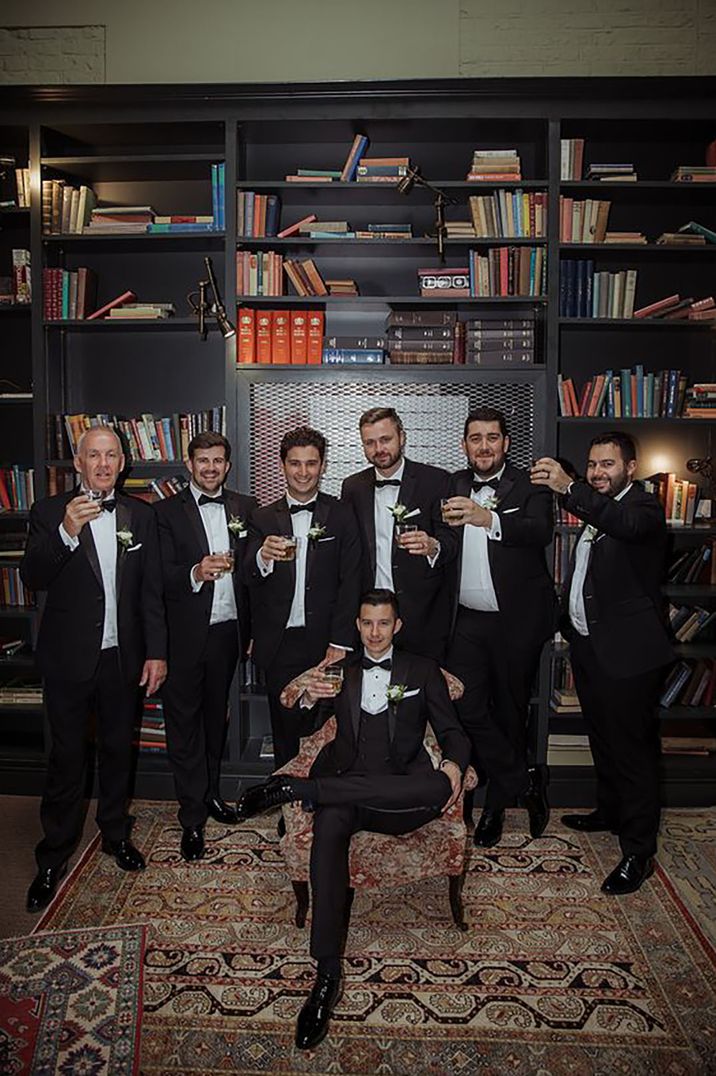 groom and groomsmen wearing matching black tuxedos