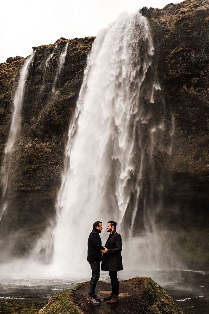 Couple stand in front of waterfall for their engagement shoot | Jason Mark Harris