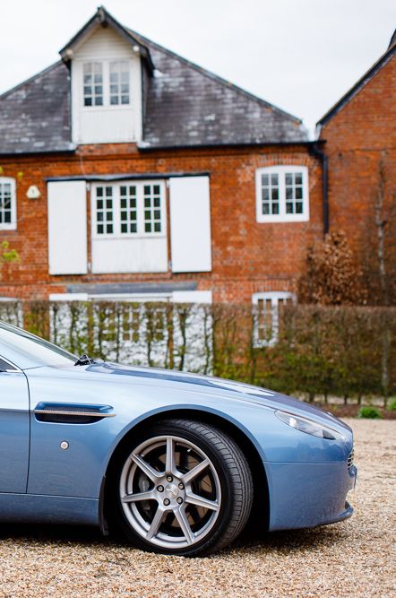 Bride and Groom Waving Everyone Off in their Something Blue Convertible Wedding Car