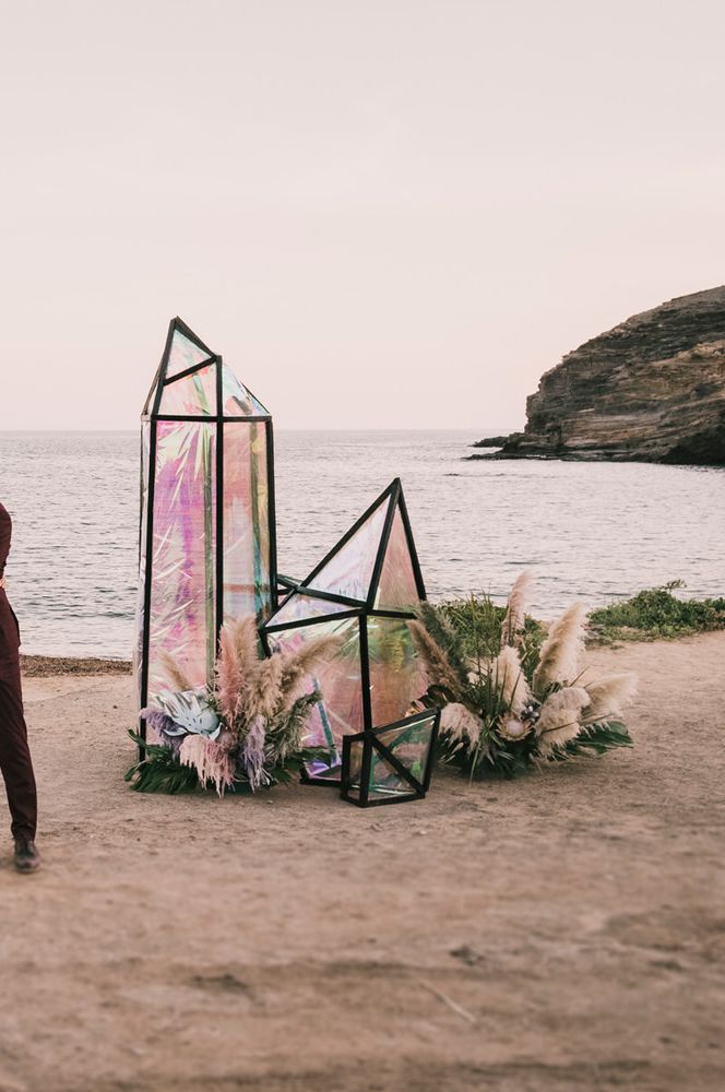 Beach weddings with irredecent geode wedding structures