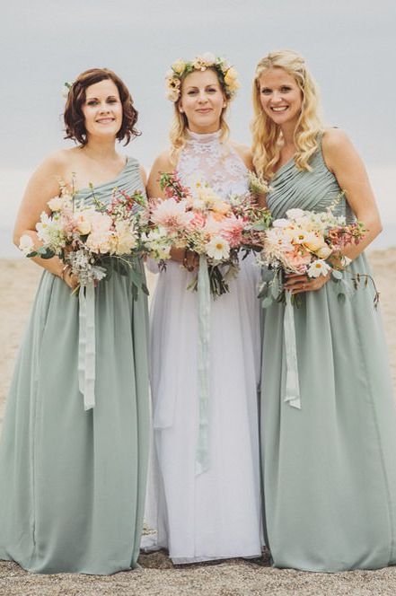 Bridesmaids in mint green dresses for coastal wedding