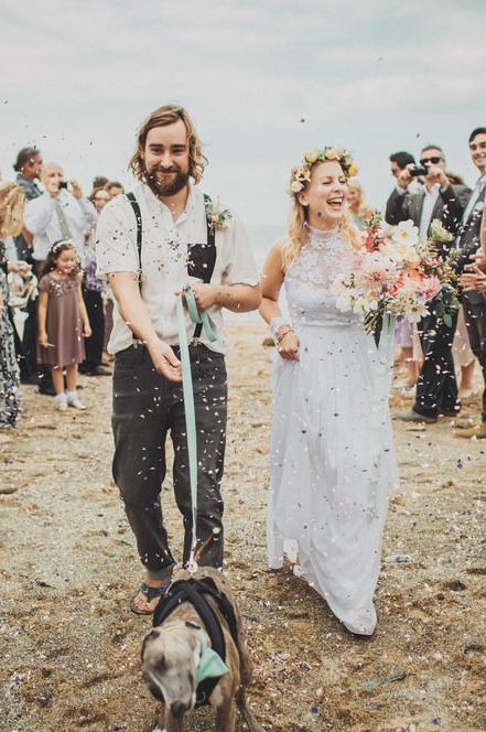 Confetti moment with pet dog at beach wedding