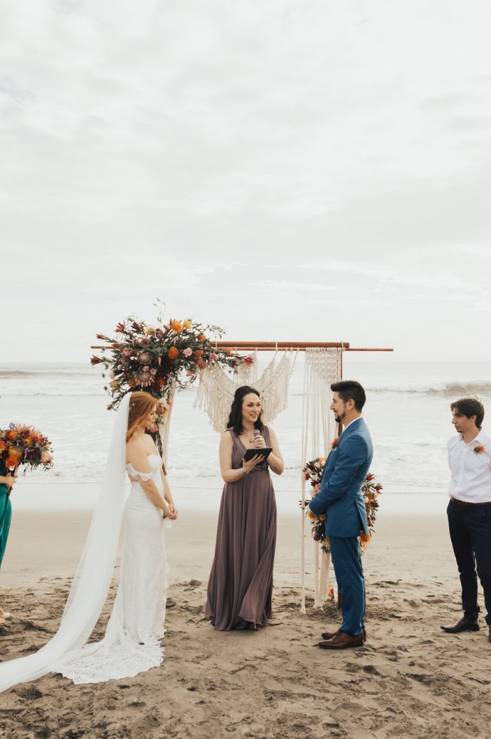 Beach wedding ceremony with wooden frame altar