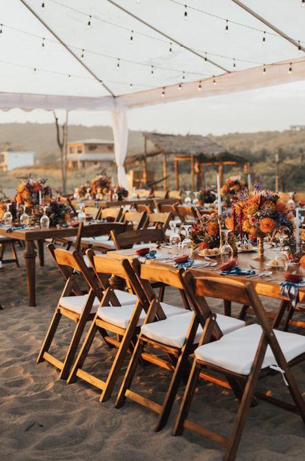 Beach weddings ceremony with orange flowers