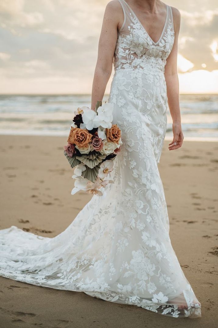 Bride in Made With Love Bridal wedding dress and orchid wedding bouquet