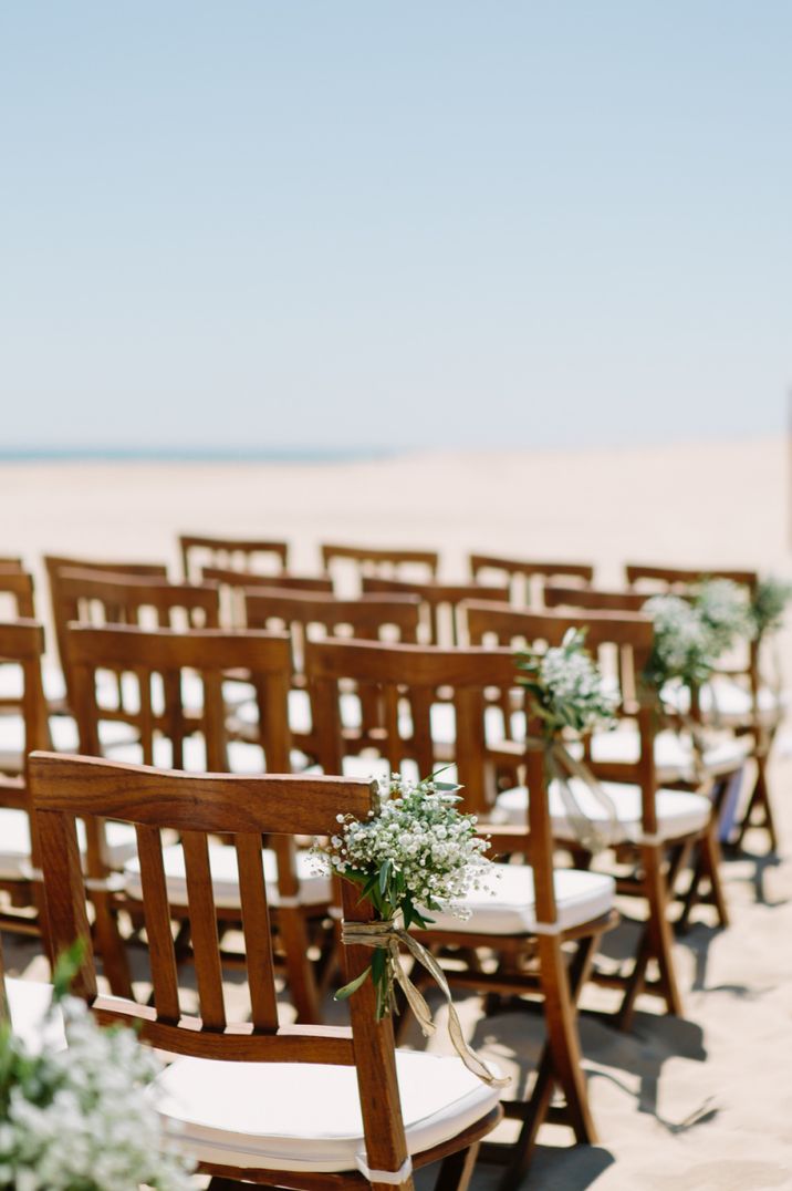 Beach wedding aisle chair flowers