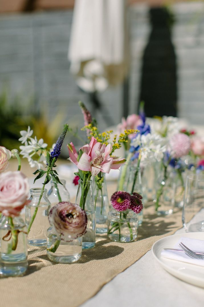 Floral wedding centrepiece using antique pink roses, narcissi and ranunculus