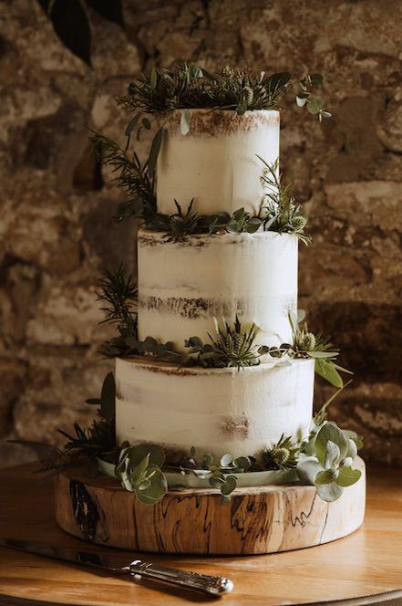 Semi naked wedding cake decorated with thistles