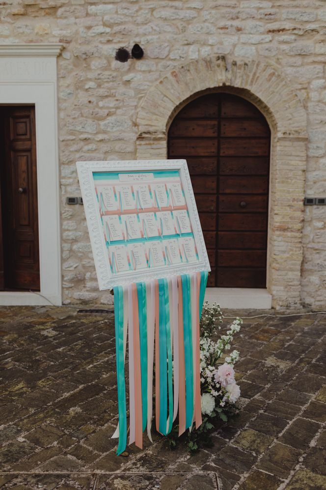 White frame table plan with ribbon decor